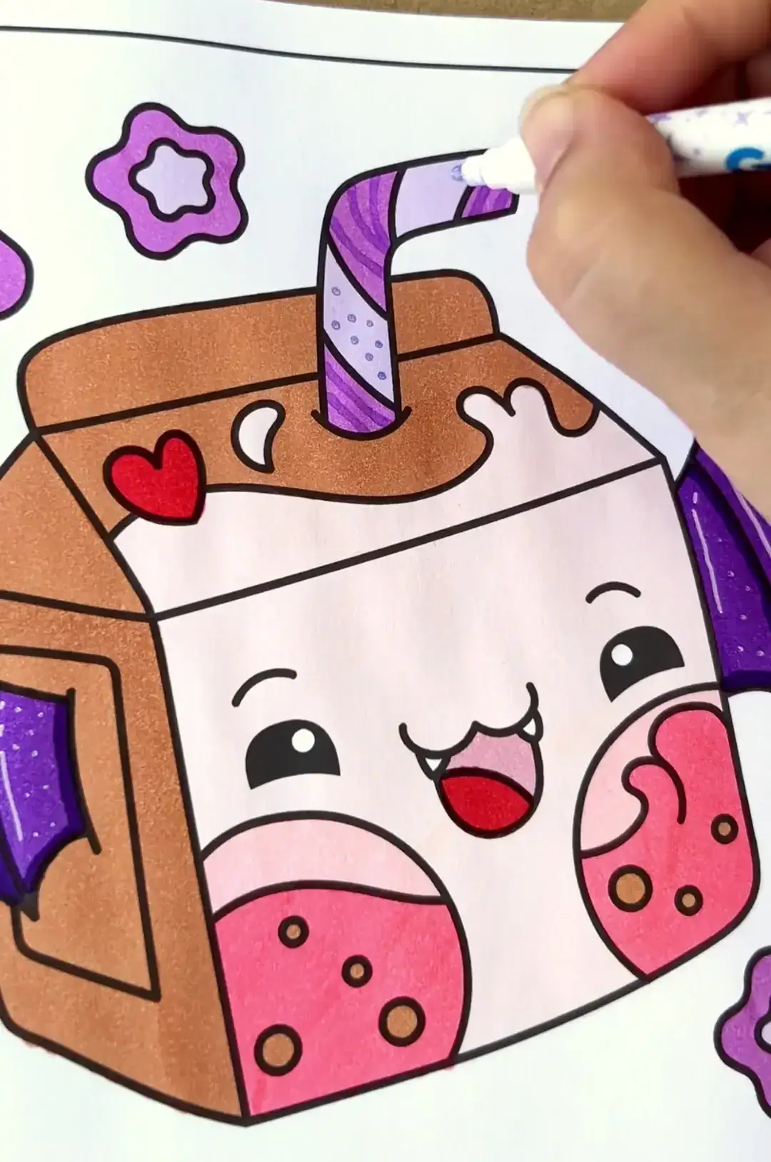 Colored pastel goth milk carton with bat wings and purple striped straw being filled in with marker.