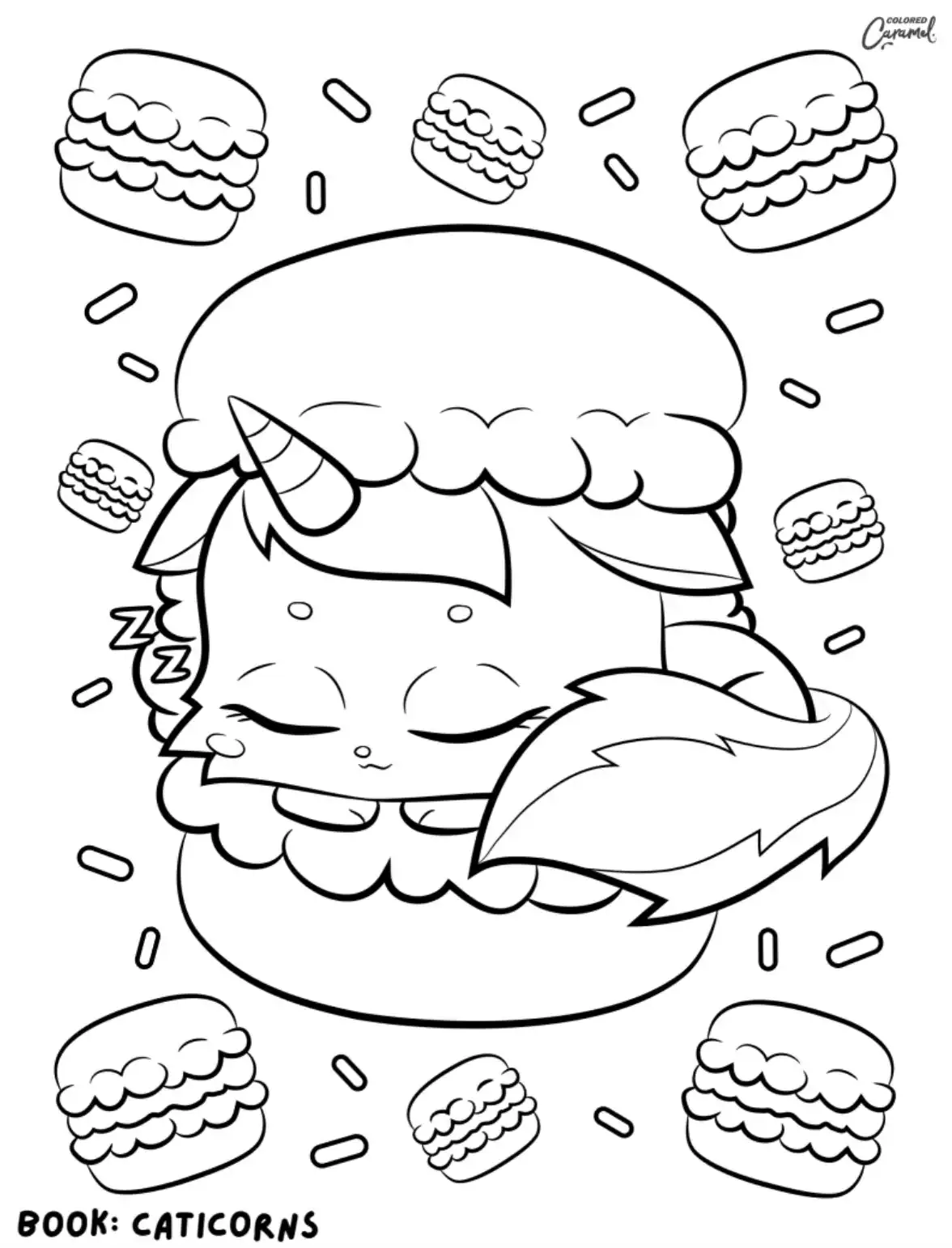 Sleepy caticorn curled up inside a giant macaron surrounded by smaller macarons and sprinkles.